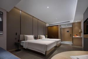 Postel nebo postele na pokoji v ubytování Atour Hotel Changsha Wangcheng District