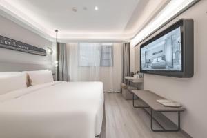 Ένα ή περισσότερα κρεβάτια σε δωμάτιο στο Atour Light Hotel Nanjing Confucius Pedestrian Street