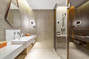 a bathroom with a sink and a shower at Atour Hotel Ya an Era Street in Ya'an +29 photos