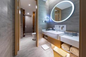 a bathroom with a sink and a mirror at Atour Hotel Wuhan Yellow Crane Tower in Wuhan