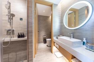 a bathroom with a sink and a mirror at Atour Hotel Wuhan Yellow Crane Tower in Wuhan