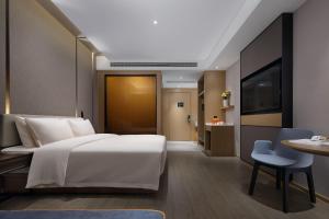 Postel nebo postele na pokoji v ubytování Atour Hotel Changsha Wangcheng District