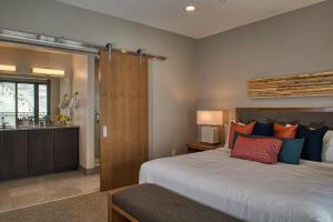 a bedroom with a large bed and a bathroom at Grand Colorado on Peak 8 in Breckenridge