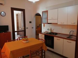 a kitchen with a table with a bowl of fruit on it at Sandro Apartment in Castellammare del Golfo