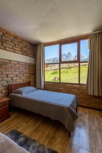 a bedroom with a bed in a room with windows at Reserva Três Picos Chalés in Nova Friburgo +36 photos