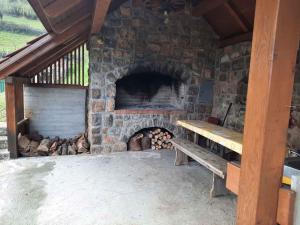a stone fireplace with a bench in front of it at Holiday home in Semic Kranjska Krain 42896 in Semič