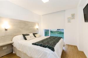 Llit o llits en una habitació de Pacífico Apartamentos Terrazas