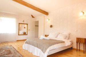 a bedroom with a large bed with white pillows at Chez Odile & Colin in Sulignat +50 photos