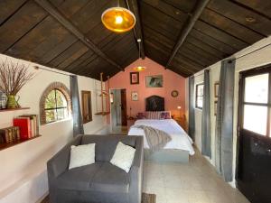 - une chambre avec un lit et un canapé dans l'établissement Rancho EL PARAÍSO AJUSCO, à Mexico