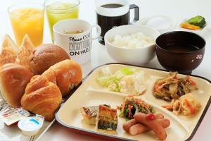 a table with a tray of food with a plate of food at Hotel Famy Inn Kinshicho in Tokyo
