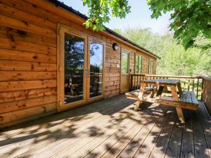 a picnic table on the deck of a cabin at Lodge Two in Truro