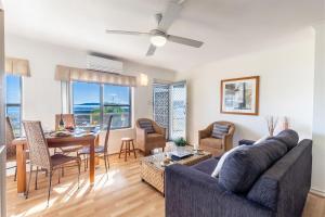 a living room with a couch and a table at Blue Vista 8 13 Victoria Parade - Studio with air con and spectacular views in Nelson Bay