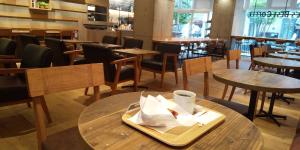 a restaurant with tables and chairs and a plate with a coffee cup at Nara Guesthouse 3F in Nara +40 photos