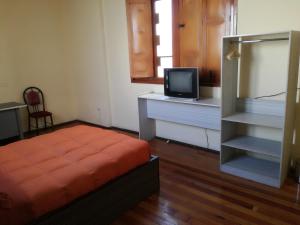 a bedroom with a bed and a tv on a desk at Luxor in Arequipa +15 photos