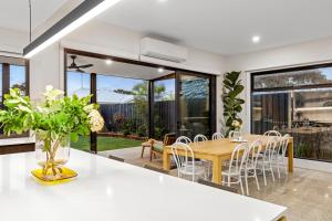 a dining room with a table and chairs at Sensational 4 Bedroom House - Free Parking - Free WIFI in Ocean Grove