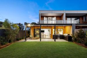 a modern house with a lawn in front of it at Sensational 4 Bedroom House - Free Parking - Free WIFI in Ocean Grove