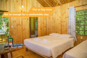 a bedroom with a bed in a wooden room at Sim Bungalow in Phú Quốc