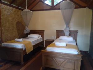 Postel nebo postele na pokoji v ubytování Bidara Cottage
