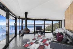 a living room with a couch and a fireplace at The Pole House in Aireys Inlet