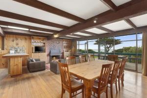 a kitchen and dining room with a wooden table and chairs at Aqua Blue in Apollo Bay