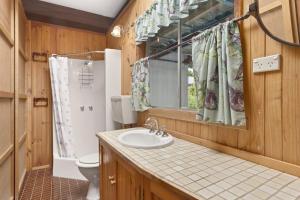 a bathroom with a sink and a toilet and a window at Aqua Blue in Apollo Bay +4 photos