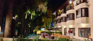 a building with tables and chairs in a courtyard at Vikram Vintage Inn in Nainital