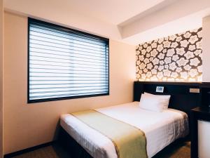 Postel nebo postele na pokoji v ubytování Shinagawa Tobu Hotel