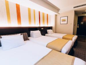 Postel nebo postele na pokoji v ubytování Shinagawa Tobu Hotel