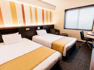 Postel nebo postele na pokoji v ubytování Shinagawa Tobu Hotel