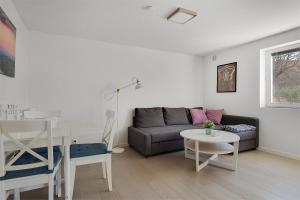 a living room with a couch and a table at Tangen in Kungshamn