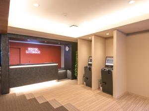 a lobby with two atm machines in a building at HOTEL LiVEMAX Hakataekimae in Fukuoka