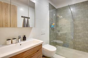a bathroom with a toilet and a sink and a shower at La vita e bella in Pješčana Uvala +24 photos