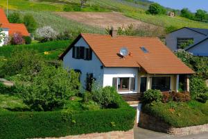 a small white house with an orange roof at Ferienweingut Wissing Wohnung Theo in Gleiszellen-Gleishorbach