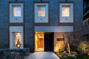 a facade of a building with a doorway at Hotel Rilassare Tokyo in Tokyo