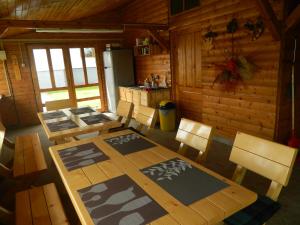 a dining room with a table and chairs in a cabin at MIRANA-Marginimea Sibiului in Cristian