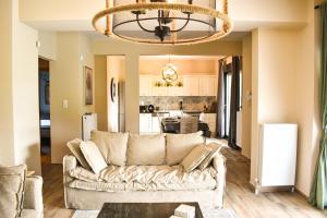 a living room with a couch and a kitchen at Aurelia Home in Alexandroupoli