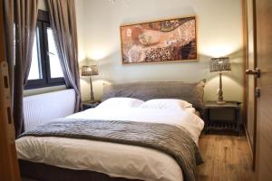 a bedroom with a bed and a painting on the wall at Aurelia Home in Alexandroupoli