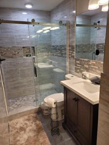 a bathroom with a shower and a sink and a toilet at Jule Sleep in Denver