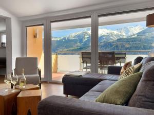 a living room with a couch and a view of a mountain at Premium apartment in Piesendorf near ski area in Piesendorf