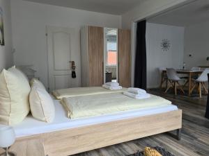 a bedroom with a large bed with pillows on it at Lütt Moor in Nordstrand