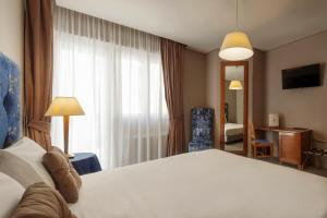 Voodi või voodid majutusasutuse BeYou Hotel Ponte Milvio toas