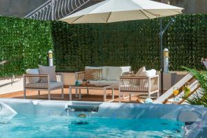 a swimming pool with chairs and an umbrella at Villa Mavis - 10 minutes to Dubrovnik in Gornji Brgat