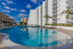 una gran piscina frente a algunos edificios en Luxury apartment in Ocean Garden Playa Paraiso, en Arona