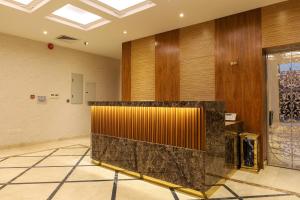 a lobby with a reception desk in a building at Tura Residence in Riyadh