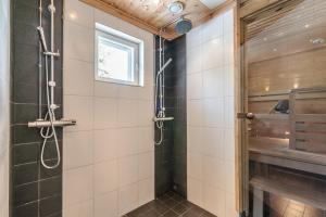a bathroom with a shower stall and a window at Levillas Stanssikuja 1 in Levi +22 photos