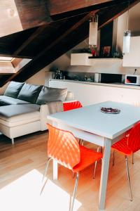 a living room with a white table and chairs at My Loft in Ferrara
