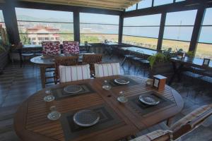 a dining room with a table and chairs and windows at Quantum Hotel in Trabzon