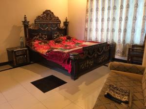 a bedroom with a large bed with a red bedspread at Three Star Hotel & Restaurent Malam jabba swat in Malam Jabba