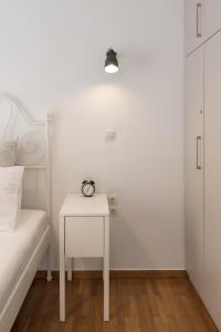 - une chambre blanche avec un lit et une table blanche dans l'établissement Amazing apartment 2 min to Acropolis, à Athènes