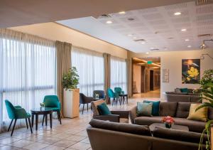 a lobby with couches and chairs and a waiting room at Lavi Kibbutz Hotel in Lavi +36 photos